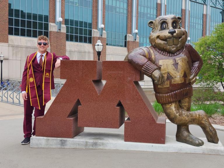 Tristen Ruesch in front of Goldy statue.