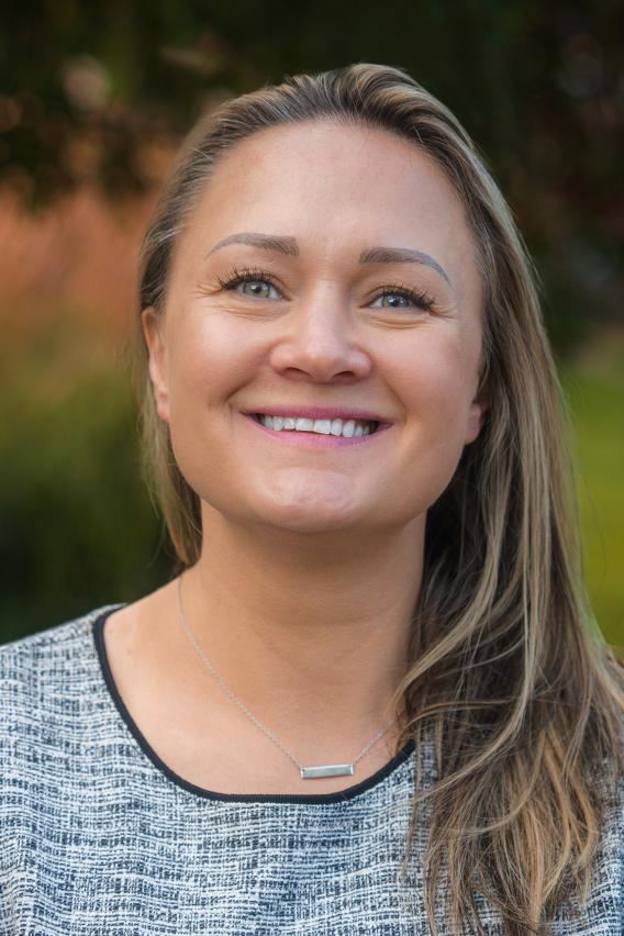 Portrait image of Candace Hogue smiling in print, crew-neck shirt
