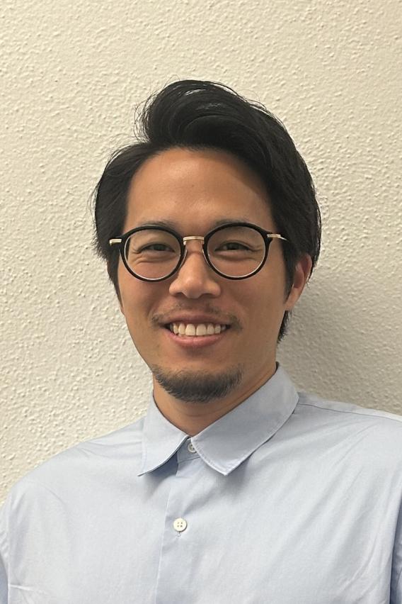 Yugo Yamaoka smiling in white shirt