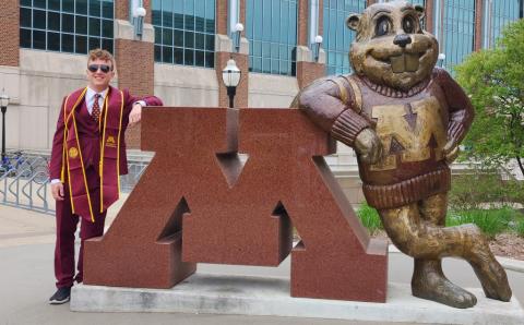 Tristen Ruesch in front of Goldy statue.